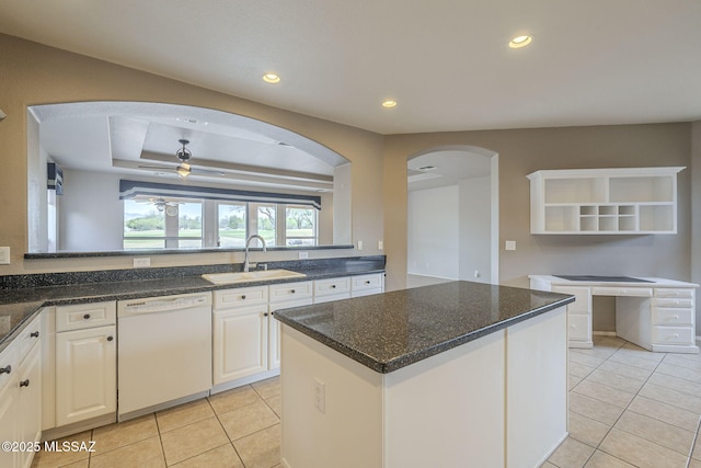 kitchen with ceiling fan, arched walkways, a sink, open shelves, and white dishwasher