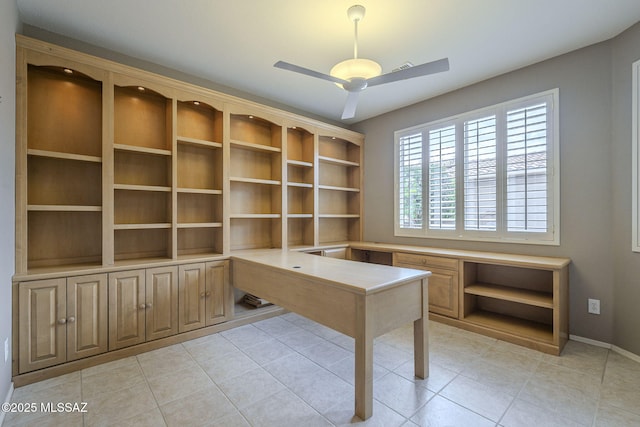 unfurnished office featuring light tile patterned flooring, baseboards, and ceiling fan