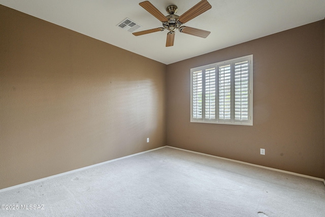 spare room with a ceiling fan, carpet floors, baseboards, and visible vents