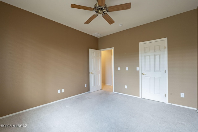 unfurnished bedroom with baseboards, visible vents, ceiling fan, and carpet