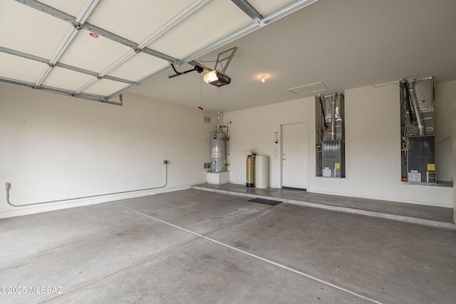 garage featuring heating unit, water heater, and a garage door opener