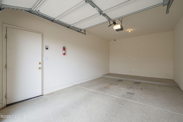 garage featuring baseboards and a garage door opener