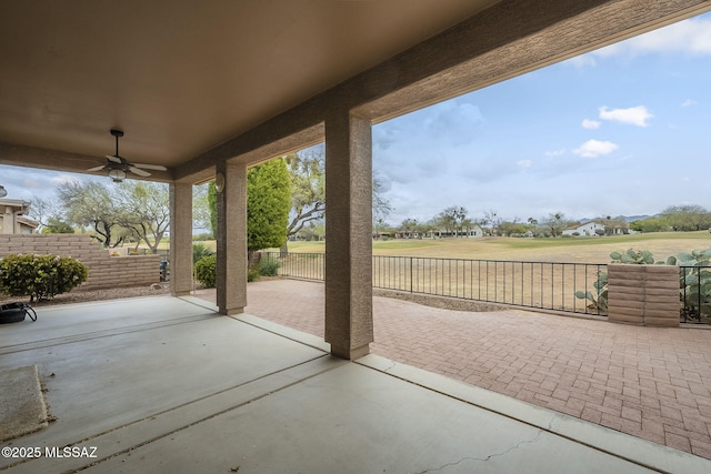 view of patio featuring fence and a ceiling fan