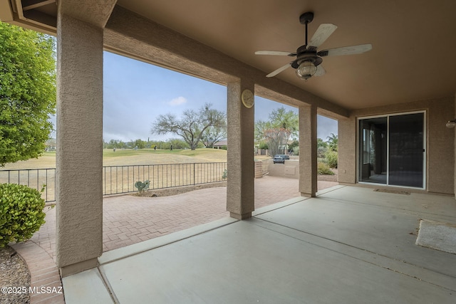 view of patio featuring fence and a ceiling fan