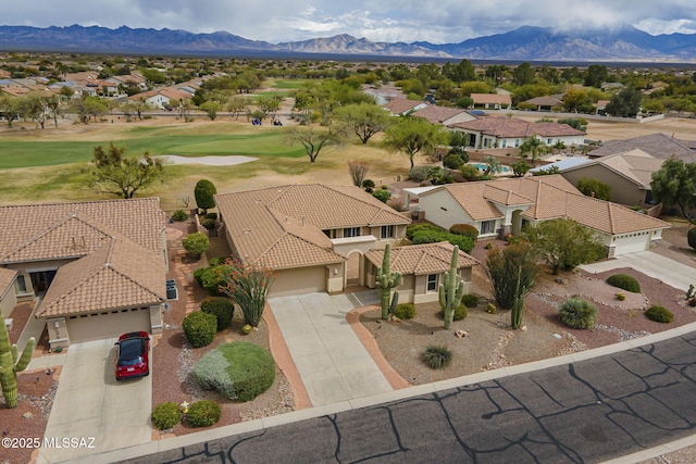 drone / aerial view featuring view of golf course, a residential view, and a mountain view