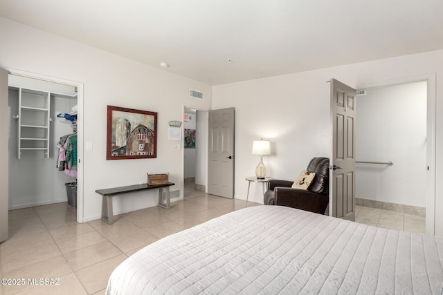 bedroom featuring a closet, visible vents, a spacious closet, and light tile patterned floors