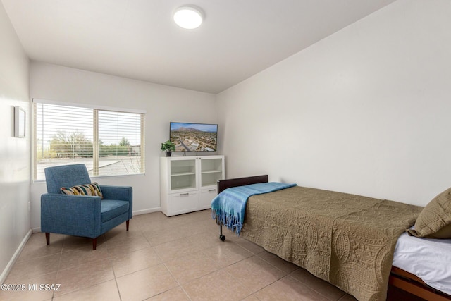 bedroom featuring light tile patterned floors and baseboards