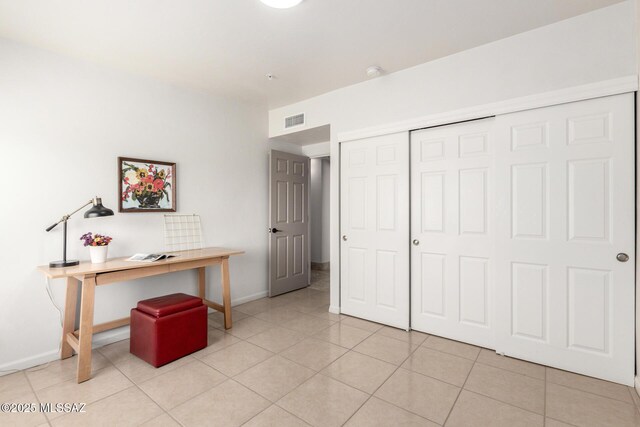 office space featuring light tile patterned floors, baseboards, and visible vents