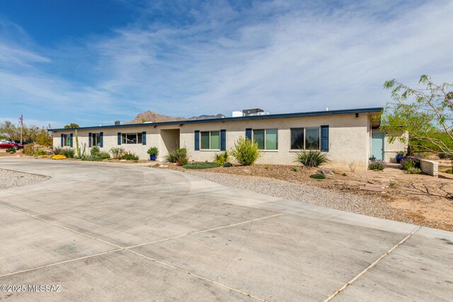 single story home featuring stucco siding