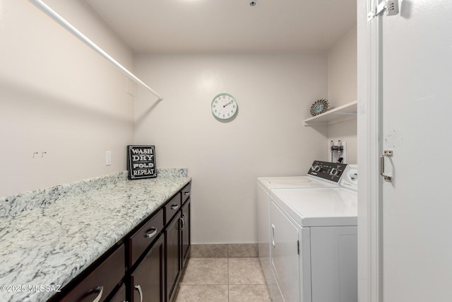 washroom with independent washer and dryer, light tile patterned flooring, cabinet space, and baseboards