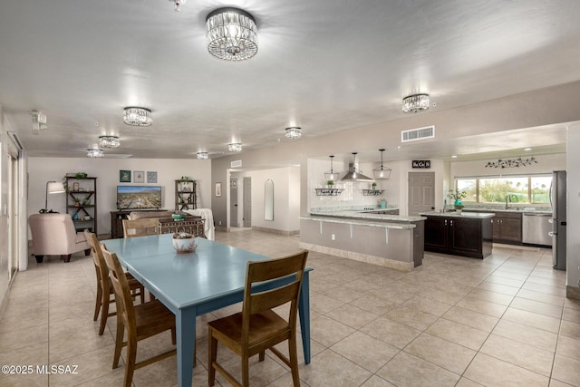 dining space with visible vents, an inviting chandelier, and light tile patterned floors