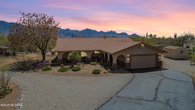4720 E Wagon Train Rd, Tucson, AZ 85739 - view of front facade featuring driveway, a tile roof, a mountain view, and stucco siding