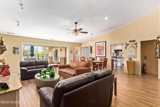 4720 E Wagon Train Rd, Tucson, AZ 85739 - living area with visible vents, a ceiling fan, light wood-style flooring, and vaulted ceiling