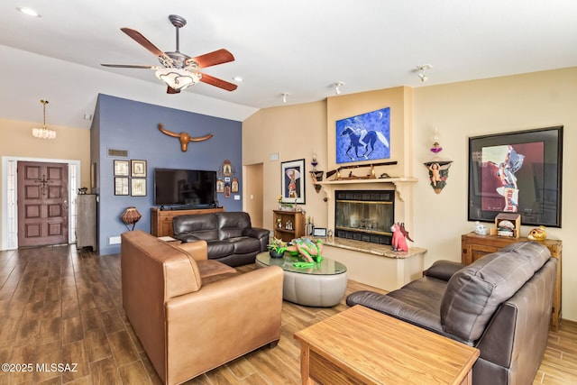 4720 E Wagon Train Rd, Tucson, AZ 85739 - living area with lofted ceiling, wood finished floors, a glass covered fireplace, and a ceiling fan