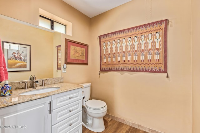 4720 E Wagon Train Rd, Tucson, AZ 85739 - bathroom with toilet, vanity, baseboards, and wood finished floors