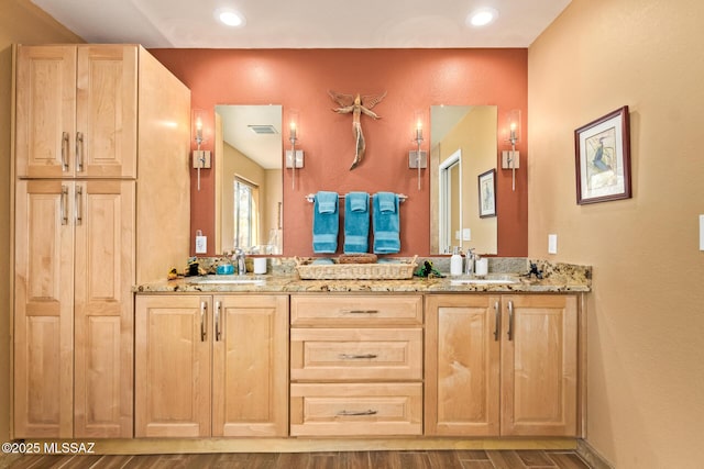 4720 E Wagon Train Rd, Tucson, AZ 85739 - full bath with double vanity, a sink, visible vents, and wood finished floors