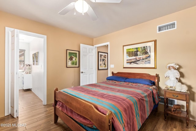 4720 E Wagon Train Rd, Tucson, AZ 85739 - bedroom with wood finished floors, ceiling fan, and visible vents