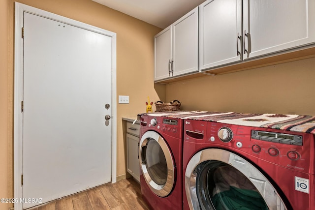4720 E Wagon Train Rd, Tucson, AZ 85739 - laundry room featuring light wood-style flooring, cabinet space, and washer and clothes dryer