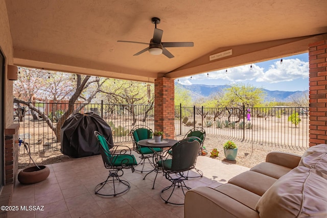 4720 E Wagon Train Rd, Tucson, AZ 85739 - view of patio / terrace featuring fence, grilling area, a mountain view, ceiling fan, and outdoor lounge area