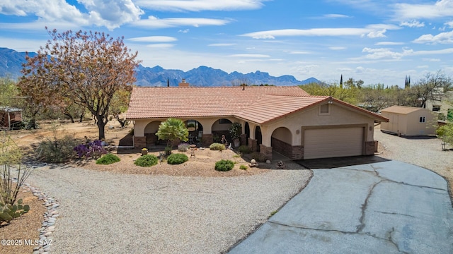 4720 E Wagon Train Rd, Tucson, AZ 85739 - view of front of home featuring driveway, a tile roof, a mountain view, and stucco siding