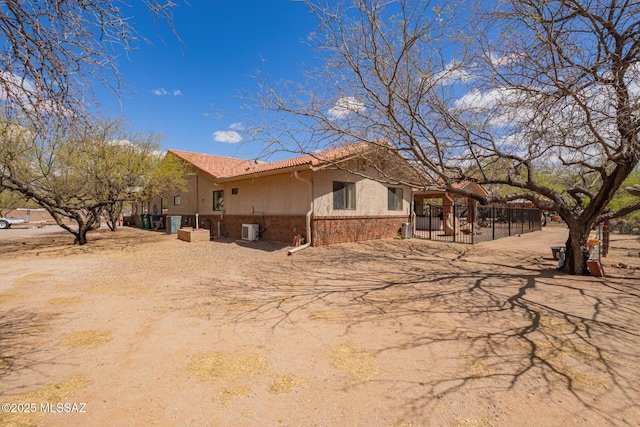 4720 E Wagon Train Rd, Tucson, AZ 85739 - exterior space featuring stucco siding, fence, and brick siding