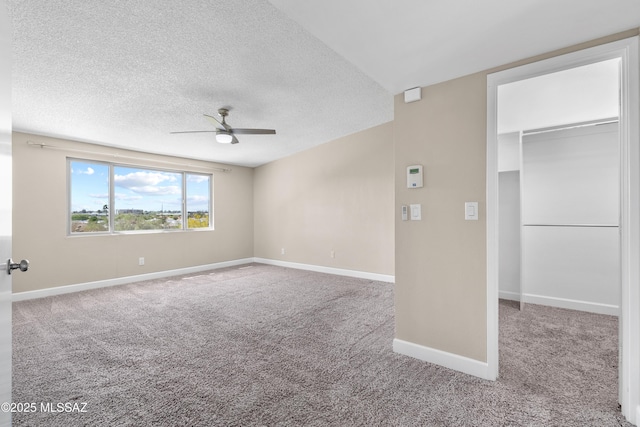 spare room with carpet floors, a textured ceiling, and ceiling fan