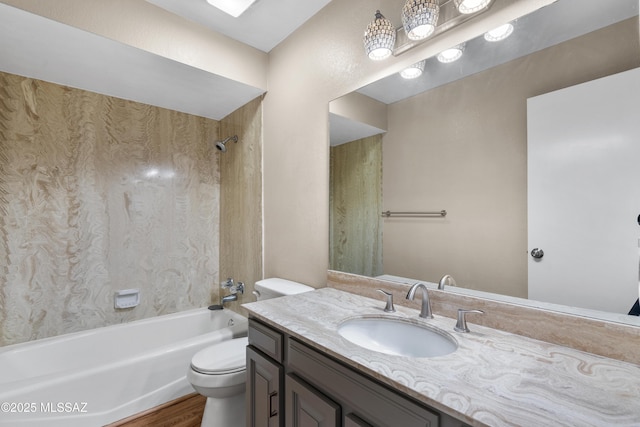 bathroom with toilet, vanity, wood finished floors, and shower / bathtub combination