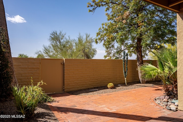 view of patio / terrace featuring fence and a gate