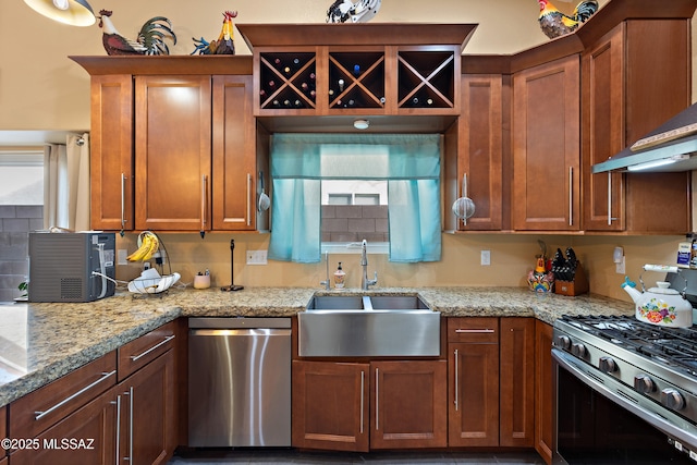 9704 E Paseo, San Rosendo, Tucson, AZ 85747 - kitchen featuring wall chimney exhaust hood, a sink, brown cabinetry, light stone countertops, and stainless steel appliances