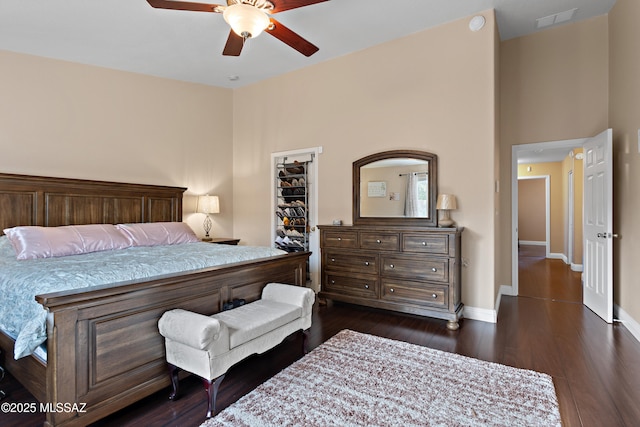9704 E Paseo, San Rosendo, Tucson, AZ 85747 - bedroom featuring baseboards, a spacious closet, dark wood-style floors, a ceiling fan, and visible vents