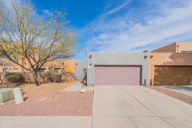 4173 N Fortune Loop, Tucson, AZ 85719 - pueblo-style home with driveway, an attached garage, and stucco siding