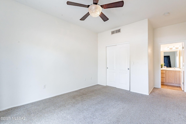 4173 N Fortune Loop, Tucson, AZ 85719 - unfurnished bedroom with light colored carpet, baseboards, connected bathroom, and ceiling fan