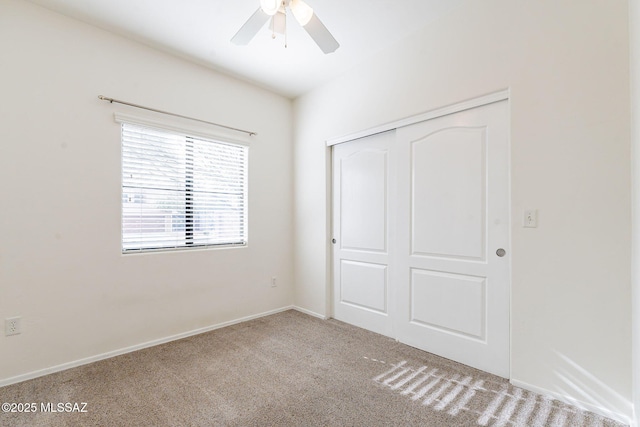 4173 N Fortune Loop, Tucson, AZ 85719 - unfurnished bedroom with carpet floors, a closet, a ceiling fan, and baseboards