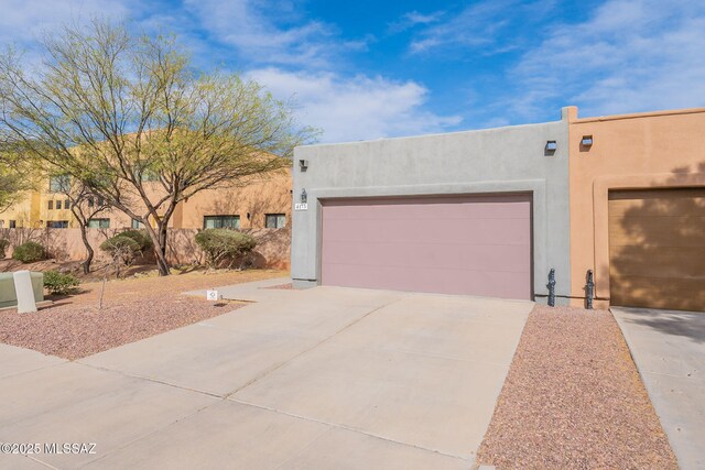 4173 N Fortune Loop, Tucson, AZ 85719 - view of front of home featuring stucco siding, concrete driveway, and a garage