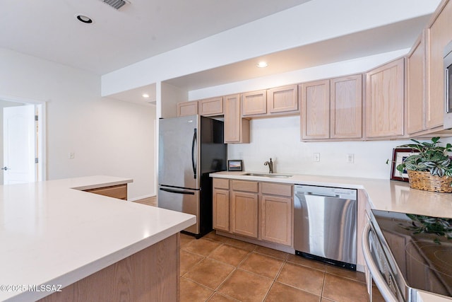 4173 N Fortune Loop, Tucson, AZ 85719 - kitchen featuring appliances with stainless steel finishes, a sink, light countertops, light brown cabinets, and recessed lighting