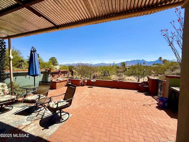 view of patio featuring a mountain view and outdoor dining space
