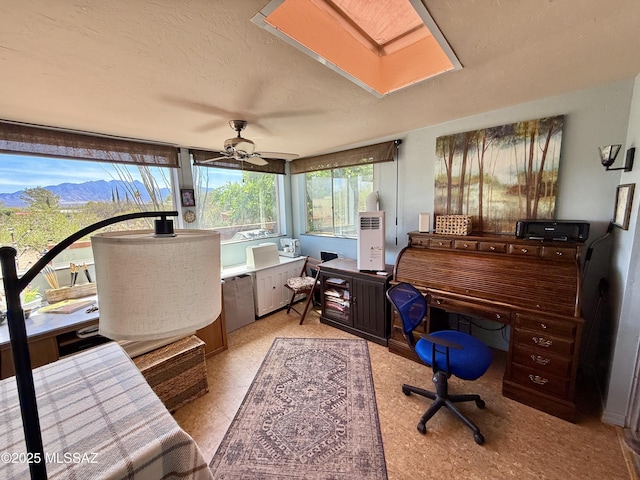 office featuring a ceiling fan and a textured ceiling