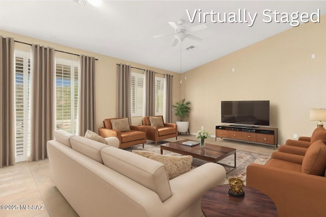 living room featuring ceiling fan, visible vents, vaulted ceiling, and light tile patterned floors