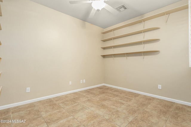 empty room with a ceiling fan, light tile patterned floors, baseboards, and visible vents
