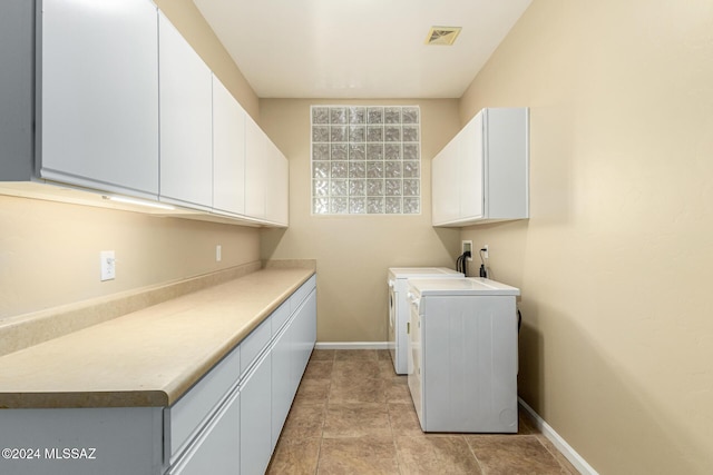 laundry area with baseboards, cabinet space, visible vents, and independent washer and dryer