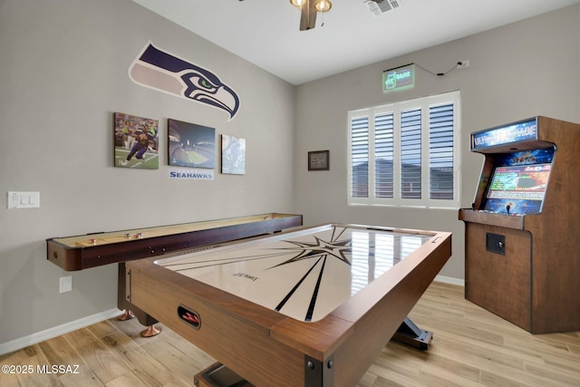 recreation room with baseboards, a ceiling fan, wood finished floors, and visible vents