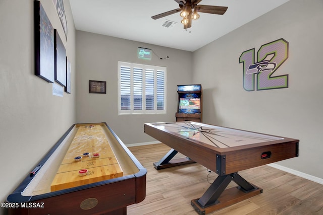 playroom featuring visible vents, a ceiling fan, baseboards, and wood finished floors