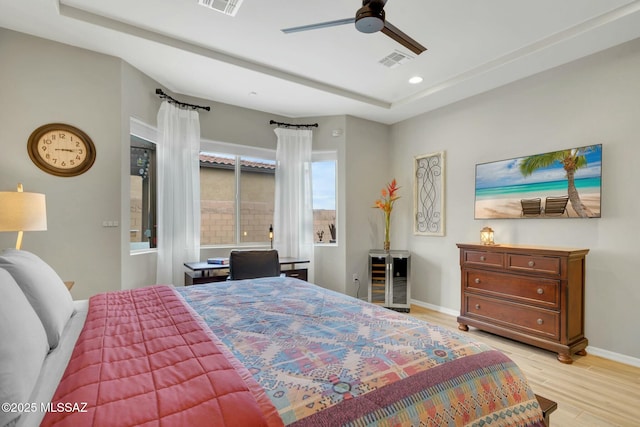 bedroom featuring light wood finished floors, beverage cooler, recessed lighting, baseboards, and visible vents