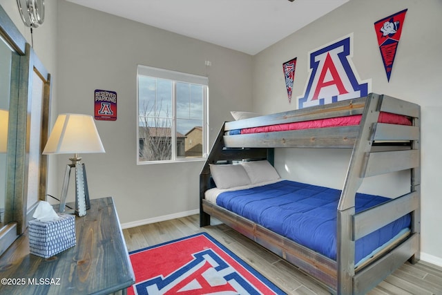 bedroom with baseboards and wood finished floors