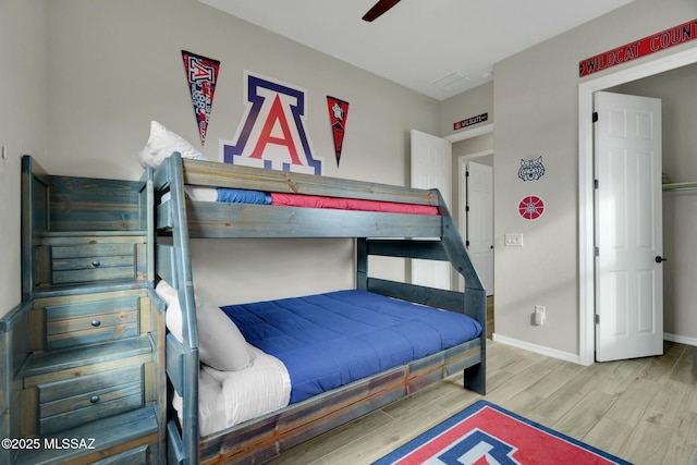 bedroom featuring baseboards, ceiling fan, and wood finished floors
