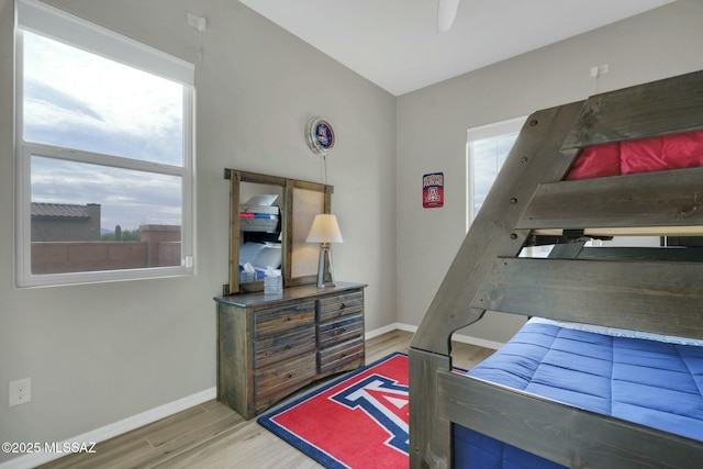 bedroom with baseboards and light wood-style flooring