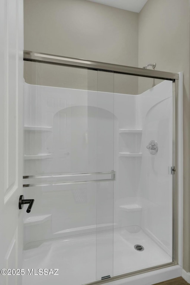full bath with a shower stall