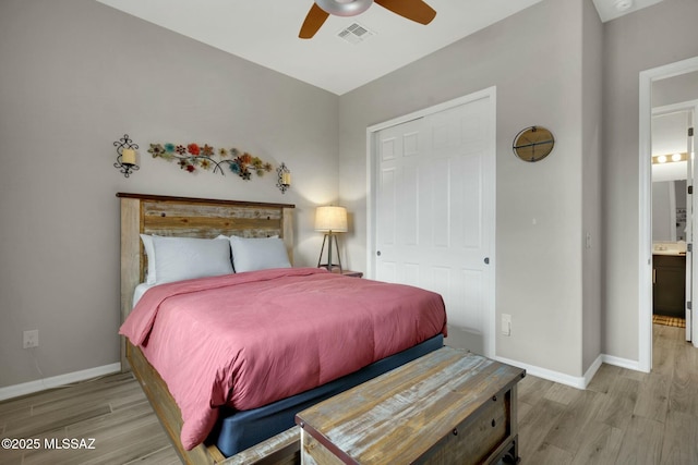 bedroom featuring a ceiling fan, baseboards, visible vents, and wood finished floors