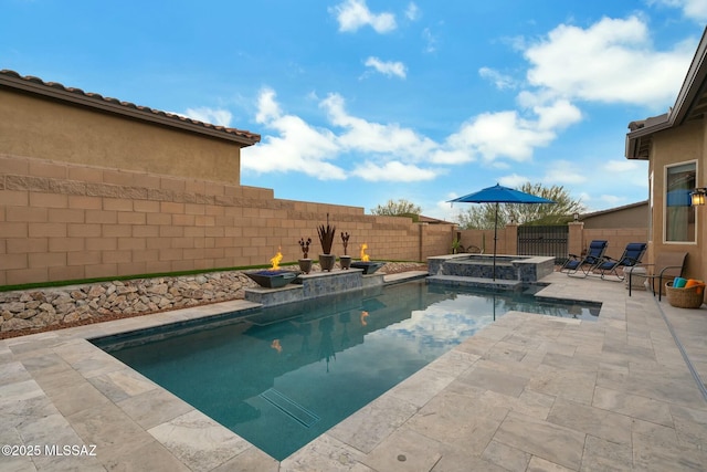 view of swimming pool with a patio, a fenced backyard, and a pool with connected hot tub