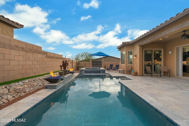 view of swimming pool featuring a fenced backyard, a pool with connected hot tub, and a patio area